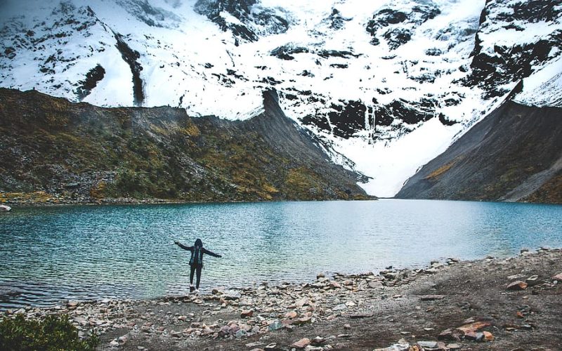 person-standing-near-lake-at-daytime